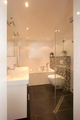 a bathroom with a tub and a sink and a toilet at Atlantis 19a in Egmond aan Zee