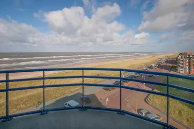 a view of the beach and the ocean from a balcony at Atlantis 19a in Egmond aan Zee