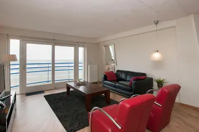 a living room with a couch and a table at Atlantis 19a in Egmond aan Zee