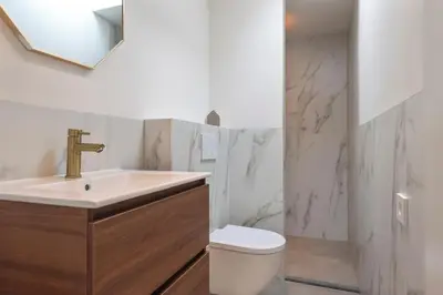 a bathroom with a sink and a toilet at Studio Campo in Bentveld