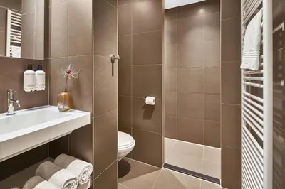 a bathroom with a toilet and a sink at Court Hotel Utrecht City Centre in Utrecht