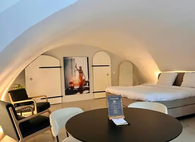 a room with a bed and a table with a laptop on it at Court Hotel Utrecht City Centre in Utrecht