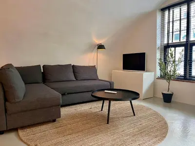 a living room with a couch and a coffee table at Court Hotel Utrecht City Centre in Utrecht
