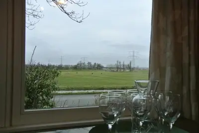 a group of wine glasses sitting on a table in front of a window at Appartement Voorhuis en chalet Klein Waterland in Amsterdam