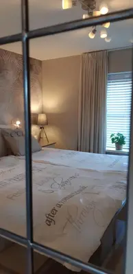 a bedroom with a bed with a sign on it at Appartement Marigold in Zandvoort