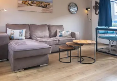 a living room with a couch and a table at Gestrand in Egmond aan Zee