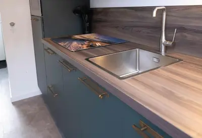 a kitchen with a sink and a wooden counter top at Gestrand in Egmond aan Zee