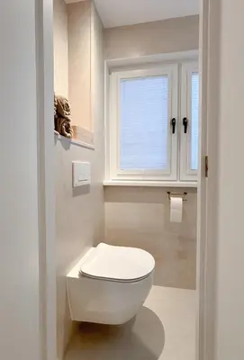 a bathroom with a white toilet and a window at Studio No3 in Katwijk aan Zee
