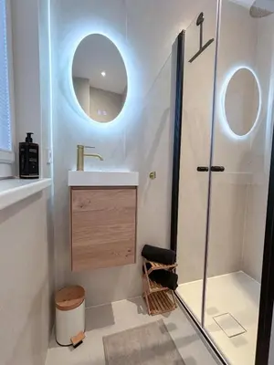 a bathroom with a shower and a sink and a mirror at Studio No3 in Katwijk aan Zee