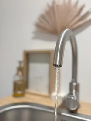 a kitchen sink with water coming out of a faucet at Studio No3 in Katwijk aan Zee