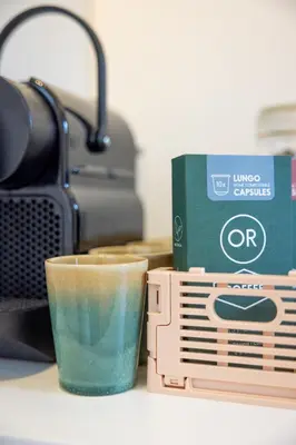 a cup of coffee and a box on a table at Boat suite - A Unique Houseboat Stay in Amsterdam in Amsterdam