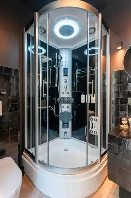 a glass shower in a bathroom with a toilet at The Gentle Arch Schiphol Amsterdam in Aalsmeer