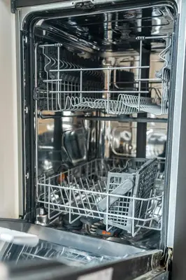 an open dishwasher with dishes in it at The Gentle Arch Schiphol Amsterdam in Aalsmeer