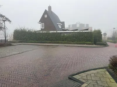 a house sitting on top of a brick road at The Gentle Arch Schiphol Amsterdam in Aalsmeer