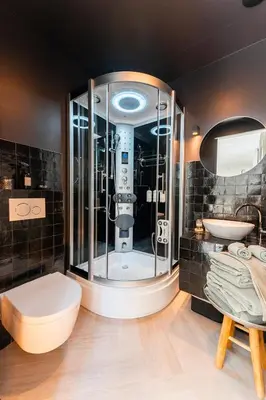 a bathroom with a shower with a toilet and a sink at The Gentle Arch Schiphol Amsterdam in Aalsmeer