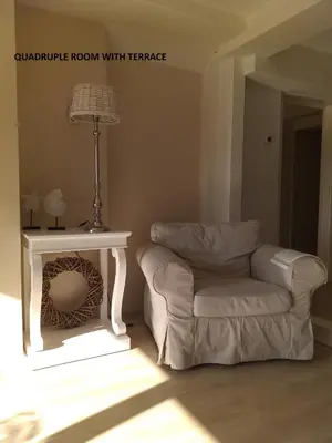 a living room with a chair and a table at El Sol Zandvoort 2 in Zandvoort