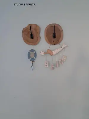 a group of three wooden clocks on a wall at El Sol Zandvoort 2 in Zandvoort