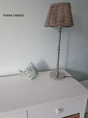 a table with a lamp and a fish toy on it at El Sol Zandvoort 2 in Zandvoort