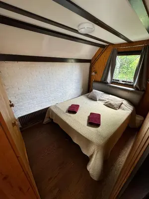 a bed in a small room with a window at Spacious Nature Escape, house for 6 near Amsterdam & Sea in Opmeer