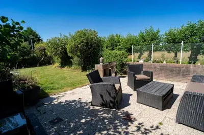 a patio with a group of chairs and a table at Spacious Nature Escape, house for 6 near Amsterdam & Sea in Opmeer