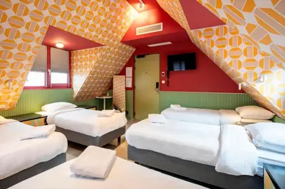 a room with a bunch of beds in it at Tourist Inn Hotel Amsterdam in Amsterdam