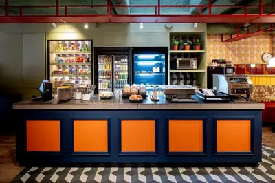 a counter in a restaurant with an orange counter top at Tourist Inn Hotel Amsterdam in Amsterdam