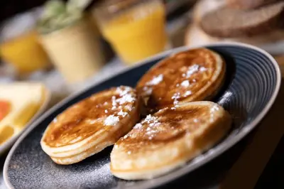 two pancakes on a plate on a table at Tourist Inn Hotel Amsterdam in Amsterdam