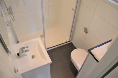 a small bathroom with a sink and a toilet at Chalet 4, Recreatie aan de Vecht in Weesp
