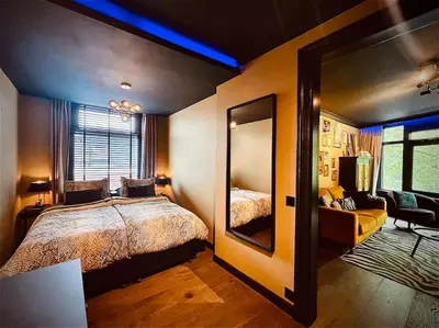 a bedroom with a large bed and a mirror at City Apartment With Canalview at Canalhouse-Majestic in Utrecht