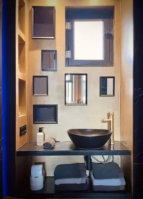 a bathroom with a bowl sink and a window at City Apartment With Canalview at Canalhouse-Majestic in Utrecht
