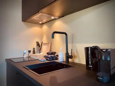 a kitchen counter with a sink and aaucet at City Apartment With Canalview at Canalhouse-Majestic in Utrecht