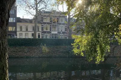 a large building in front of a body of water at Cosy Penthouse with Rooftop Canalhouse-Majestic in Utrecht