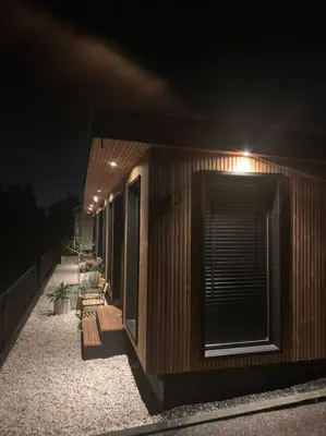a building with a light on the side at night at R&M Boutique in Lijnden