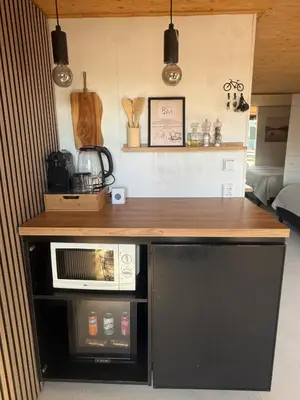 a kitchen with a counter top and a microwave at R&M Boutique in Lijnden