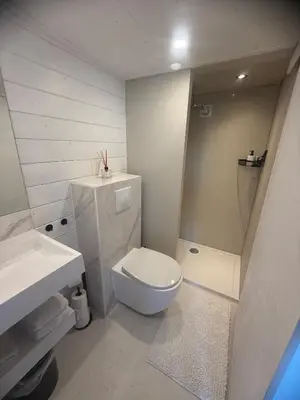 a white bathroom with a toilet and a sink at R&M Boutique in Lijnden