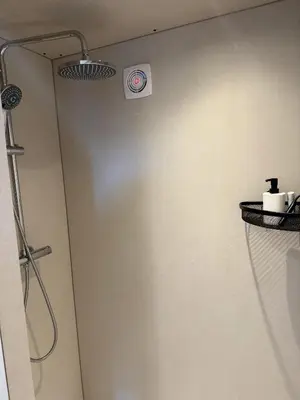 a bathroom with a shower with a shower head at R&M Boutique in Lijnden