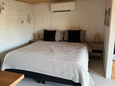a bedroom with a large bed in a room at R&M Boutique in Lijnden