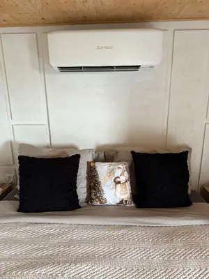 a bed with black pillows and a white ceiling at R&M Boutique in Lijnden