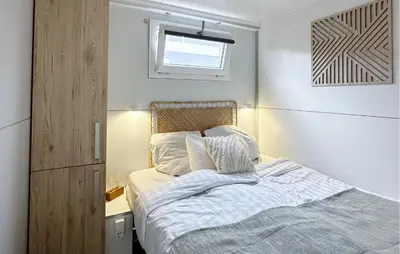 a small bedroom with a bed and a window at Jack Sparrow in Almere