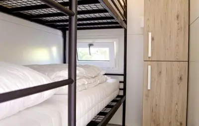 a bedroom with two bunk beds and a window at Jack Sparrow in Almere