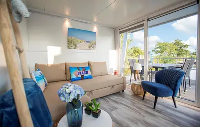 a living room with a couch and a balcony at Jack Sparrow in Almere