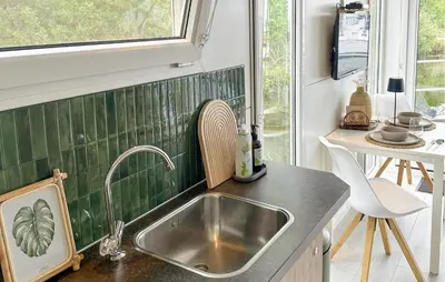 a kitchen with a sink and a window at Blackbeard in Almere