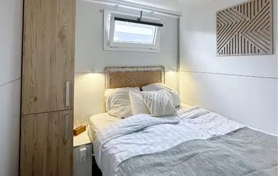 a small bedroom with a bed and a window at Blackbeard in Almere