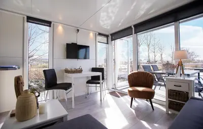 a living room with a table and chairs at Blackbeard in Almere