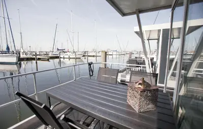 a dog sitting on a bench on a boat at Davy Jones in Almere