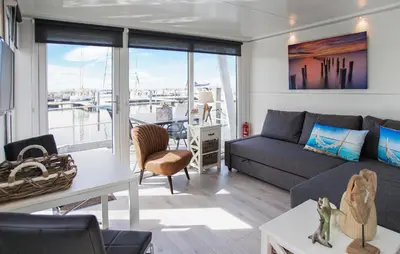 a living room with a couch and a table at Davy Jones in Almere