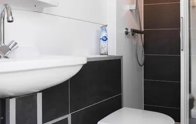 a bathroom with a sink and a toilet and a shower at Barbossa in Almere