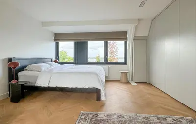 a bedroom with a bed and a large window at Beautiful Home In Loosdrecht With Wifi in Loosdrecht