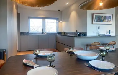 a dining room table with plates and wine glasses at Beautiful Home In Loosdrecht With Wifi in Loosdrecht