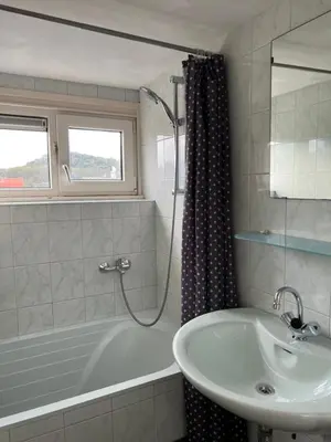 a bathroom with a bath tub and a sink at ZilverMoon in Egmond aan Zee